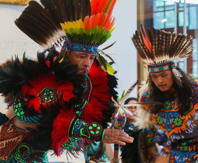 Edward Jaramillo (left) helps lead the Tonantzin Yaotecas Aztec Dancers during the Powwow of Arts and Culture at the Delaware Art Museum, Saturday, July 23, 2022.